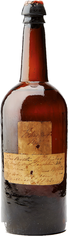 A dark glass bottle with a handwritten paper label dated 1843