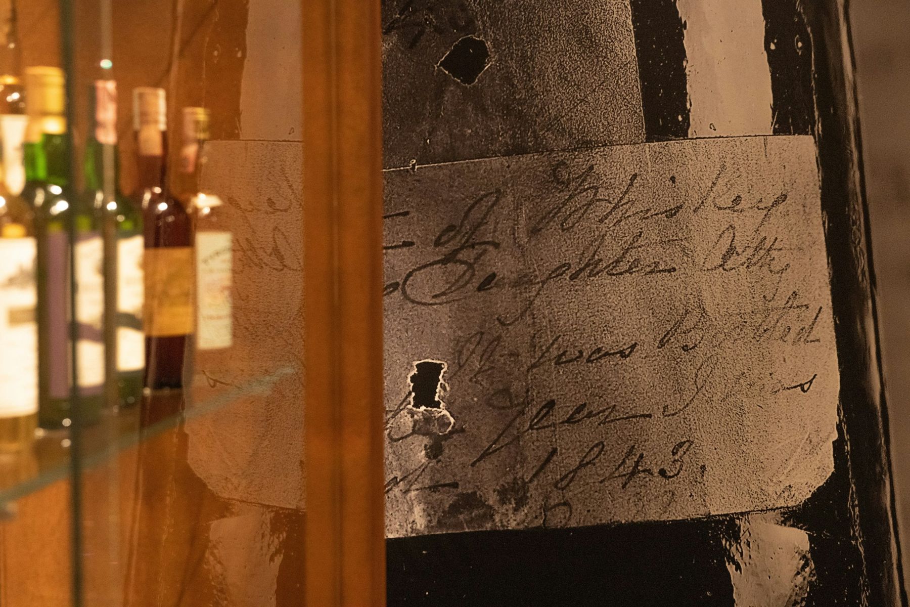 The handwritten 1843 label behind glass in the exhibition